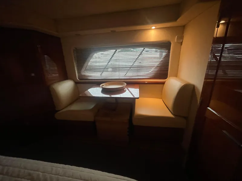 Slide: The Image of Interior of 2008 Sea Ray 550 Sundancer yacht with cozy dining area and window blinds. - 47