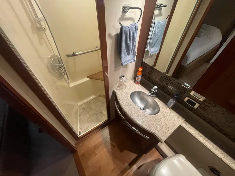 Slide: The Image of Bathroom interior of 2008 Sea Ray 550 Sundancer yacht, featuring shower, sink, and towel rack. - 48