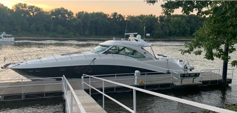 Slide: The Image of 2008 Sea Ray 550 Sundancer yacht docked by a scenic river at sunset. - 6