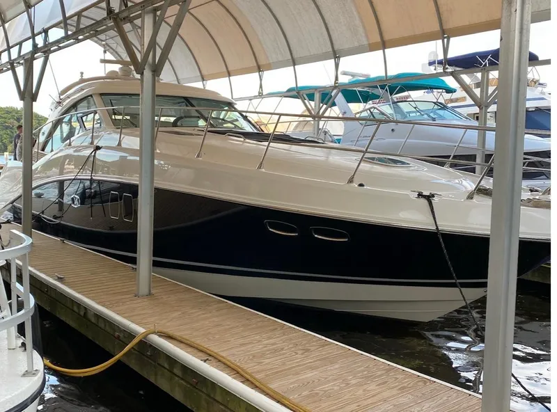 Slide: The Image of 2008 Sea Ray 550 Sundancer yacht docked under a canopy. - 8