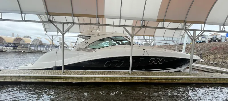 Slide: The Image of 2008 Sea Ray 550 Sundancer yacht docked under a canopy at a marina. - 9