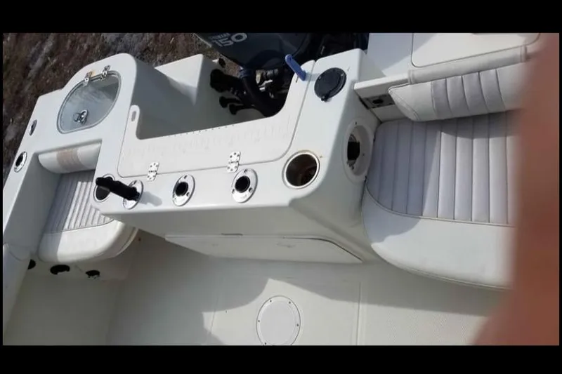 Slide: The Image of 2009 Sailfish 218 CC boat interior with seating and fishing rod holders. - 11