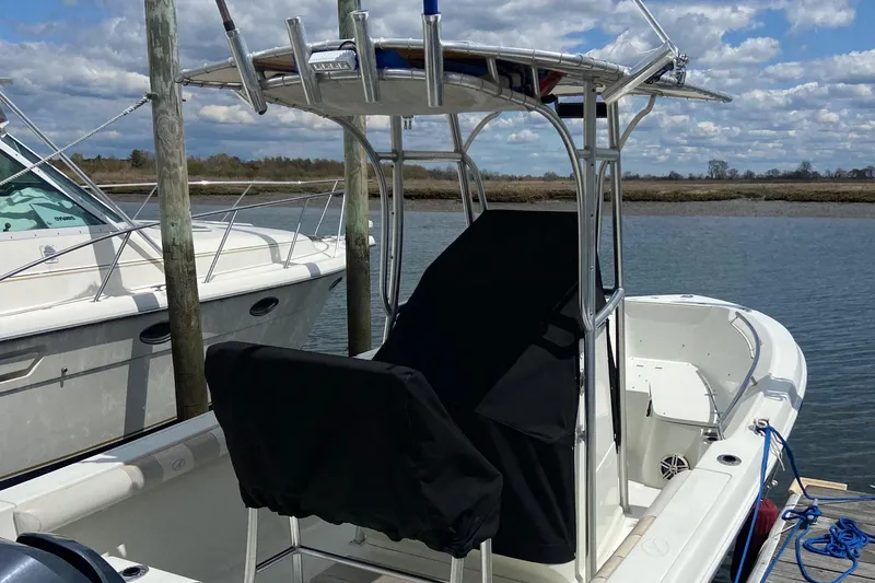Slide: The Image of 2009 Sailfish 218 CC boat docked by the water on a sunny day. - 19