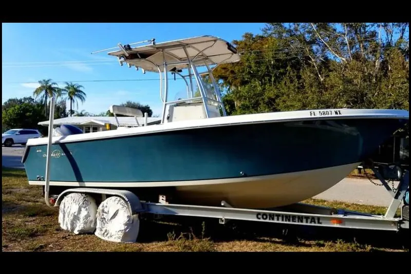 Slide: The Image of 2009 Sailfish 218 CC boat on trailer, parked outdoors. - 4