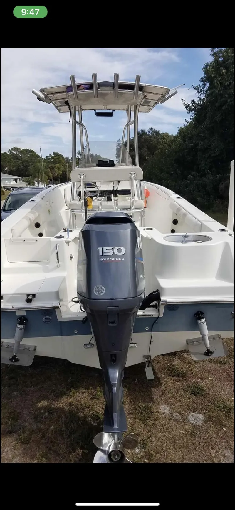Slide: The Image of 2009 Sailfish 218 CC boat with Yamaha 150 outboard motor, parked on grass. - 8