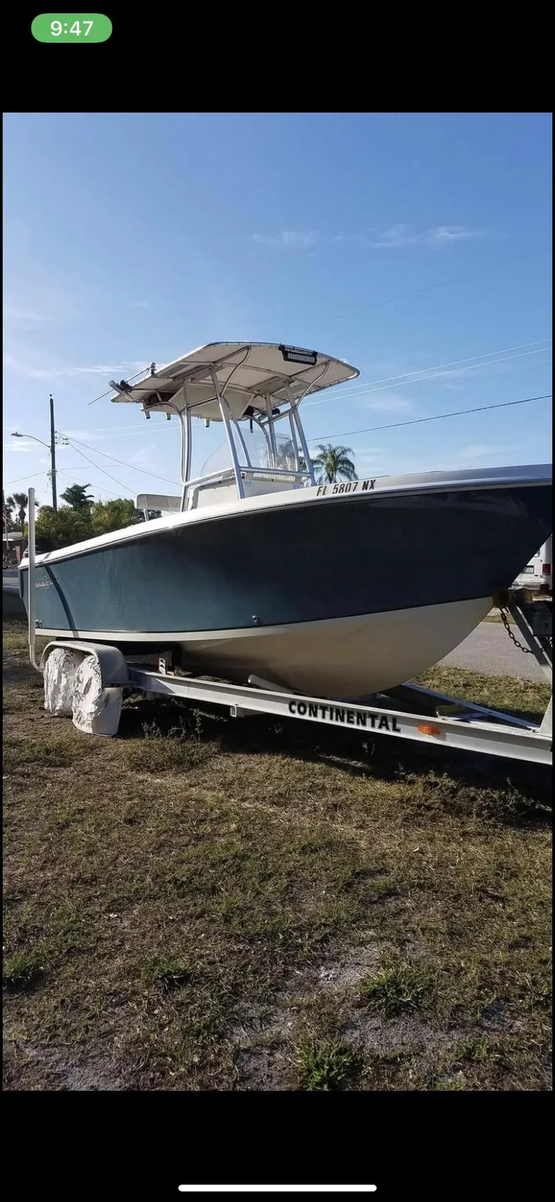 Slide: The Image of 2009 Sailfish 218 CC boat on trailer under clear blue sky. - 9