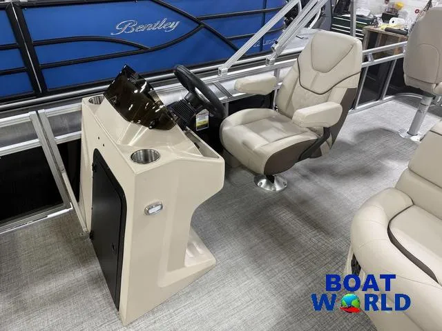Slide: The Image of 2025 Tahoe Sport 2385 boat interior with steering console and comfortable seating. - 11