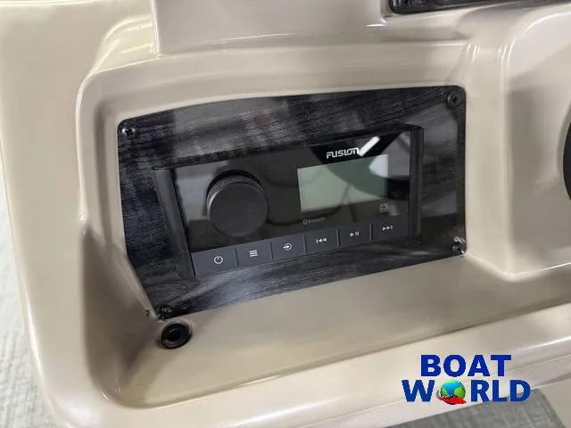 Slide: The Image of Control panel of 2025 Tahoe Sport 2385 boat with Fusion audio system. - 14