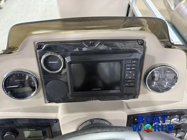 Slide: The Image of Dashboard of 2025 Tahoe Sport 2385 with Garmin display and Honda controls. - 15