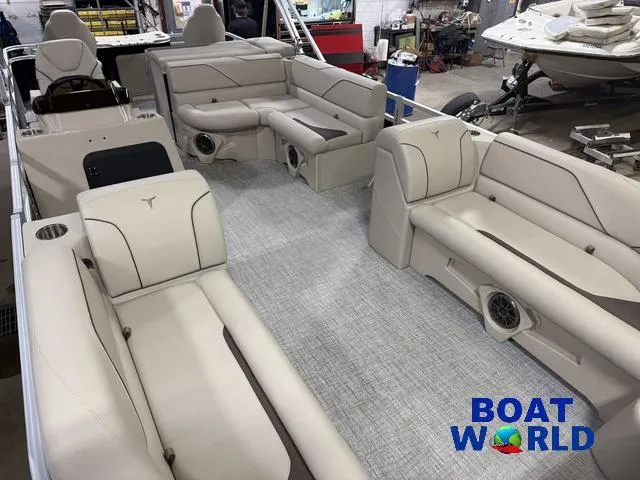 Slide: The Image of 2025 Tahoe Sport 2385 Rear Fish boat interior with beige seating and "Boat World" logo. - 26