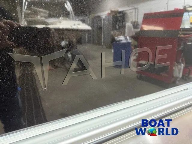 Slide: The Image of 2025 Tahoe Sport 2385 Rear Fish boat logo in a workshop setting. - 31