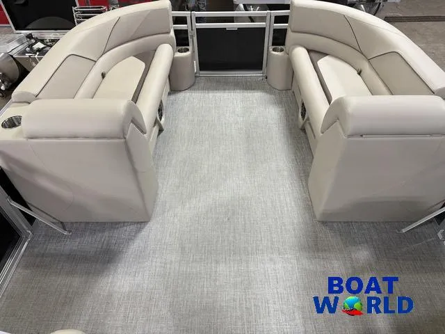 Slide: The Image of 2025 Tahoe Sport 2385 Rear Fish interior with beige seating and "Boat World" logo. - 33