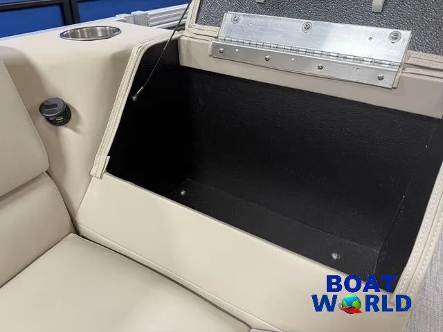 Slide: The Image of 2025 Tahoe Sport 2385 Rear Fish boat storage compartment with beige seating and cup holder. - 34