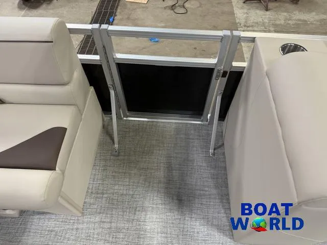 Slide: The Image of 2025 Tahoe Sport 2385 boat interior with seating and gate, featuring Boat World logo. - 36