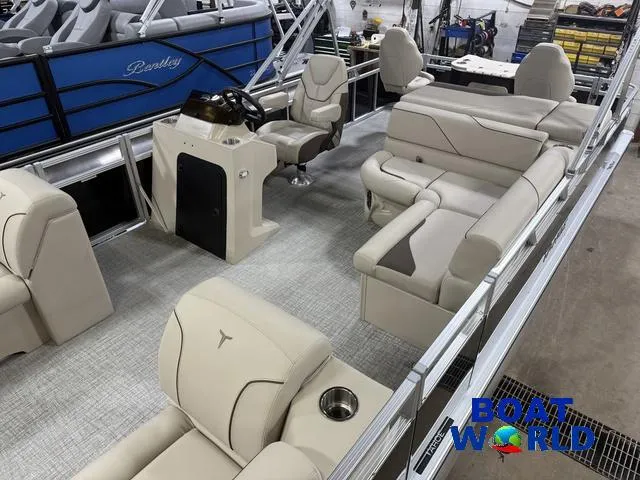 Slide: The Image of 2025 Tahoe Sport 2385 Rear Fish boat interior with beige seating and steering console. - 4