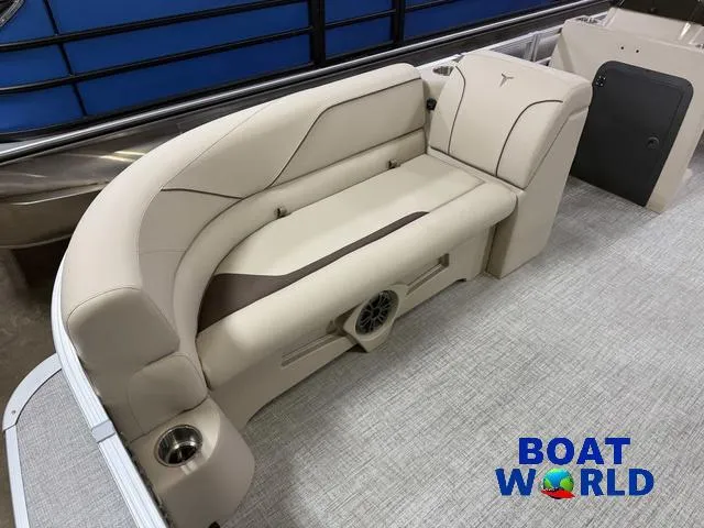 Slide: The Image of 2025 Tahoe Sport 2385 Rear Fish boat interior with beige seating and speaker. - 8