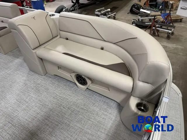 Slide: The Image of 2025 Tahoe Sport 2385 Rear Fish boat interior with beige seating and cup holders. - 9