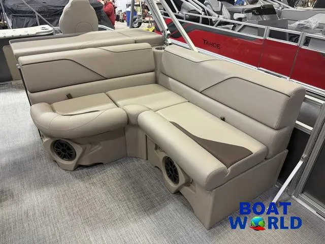 Slide: The Image of 2025 Tahoe Sport 2385 boat interior with beige seating and built-in speakers. - 10