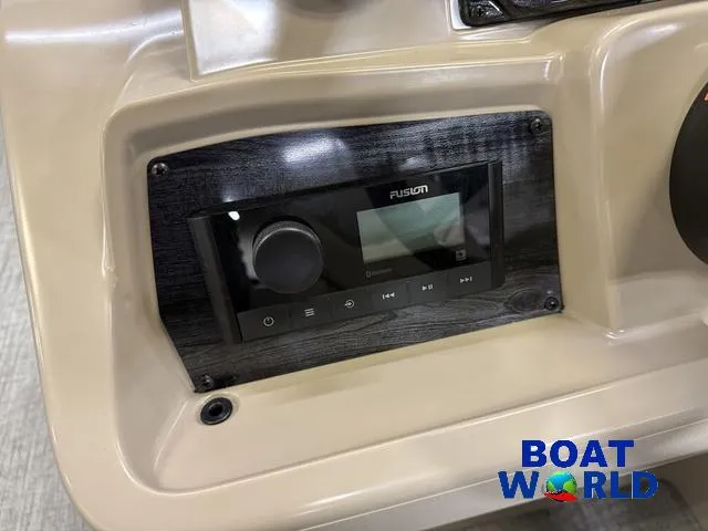Slide: The Image of 2025 Tahoe Sport 2385 boat dashboard with Fusion audio system, Boat World logo visible. - 14