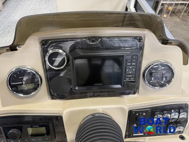 Slide: The Image of Dashboard of 2025 Tahoe Sport 2385 with Garmin display and Honda controls. - 15