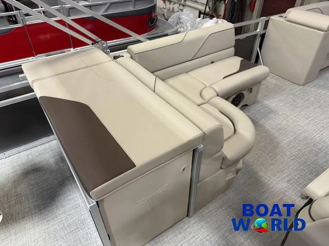 Slide: The Image of 2025 Tahoe Sport 2385 Rear Fish boat interior with beige seating and "Boat World" logo. - 18