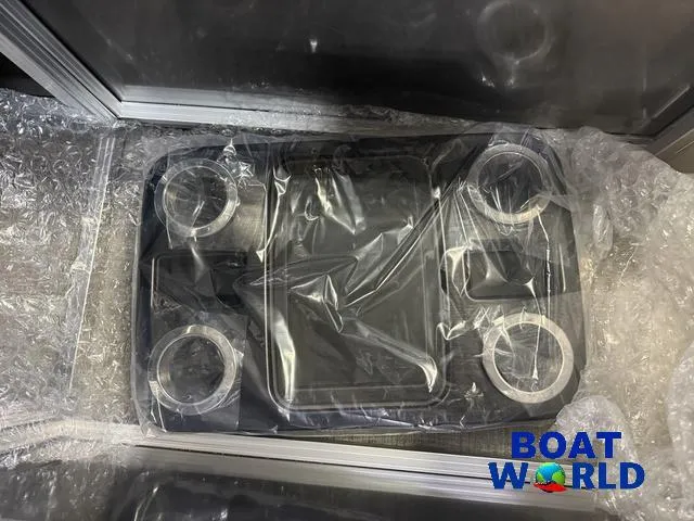 Slide: The Image of 2025 Tahoe Sport 2385 Rear Fish console, wrapped in protective packaging, featuring cup holders. - 19