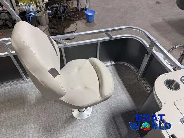 Slide: The Image of 2025 Tahoe Sport 2385 boat seat, beige upholstery, in showroom setting. - 22