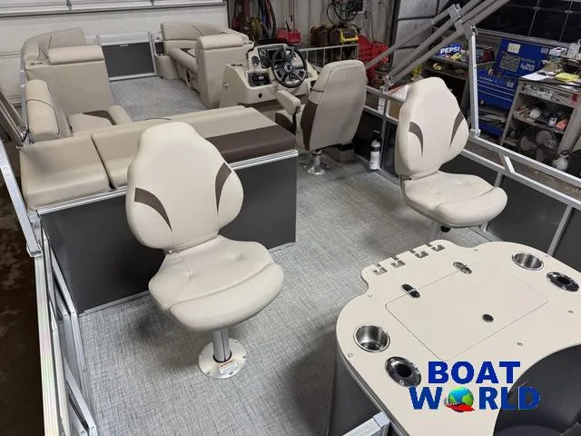 Slide: The Image of 2025 Tahoe Sport 2385 Rear Fish boat interior with seating and fishing setup. - 23