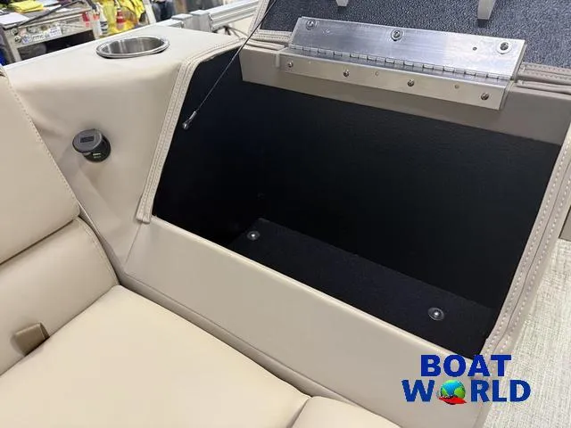 Slide: The Image of 2025 Tahoe Sport 2385 boat interior with storage compartment and cup holder. - 26