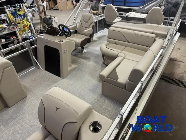Slide: The Image of 2025 Tahoe Sport 2385 Rear Fish boat interior with beige seating and steering console. - 4