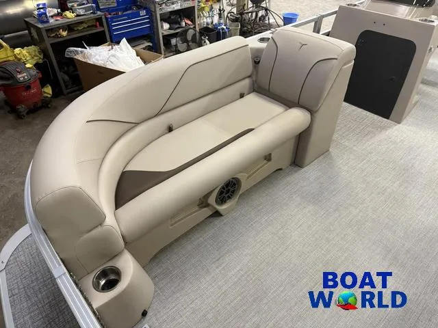 Slide: The Image of 2025 Tahoe Sport 2385 boat interior with beige seating and cup holder, showcased at Boat World. - 8