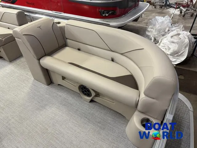 Slide: The Image of 2025 Tahoe Sport 2385 boat interior with beige seating and speaker system. - 9