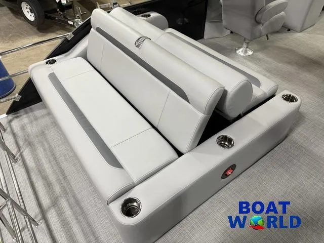 Slide: The Image of 2025 Bentley Pontoons Legacy 220 Swingback interior seating with cup holders, showcased at Boat World. - 2