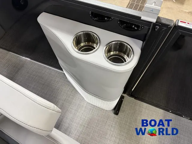 Slide: The Image of 2025 Bentley Pontoons Legacy 220 Swingback interior with cup holders, featuring Boat World logo. - 26