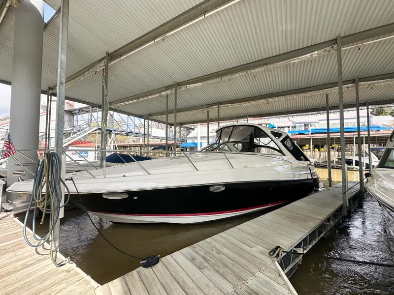 Slide: The Image of 2007 Regal Commodore 3760 IO boat docked under a covered marina. - 0