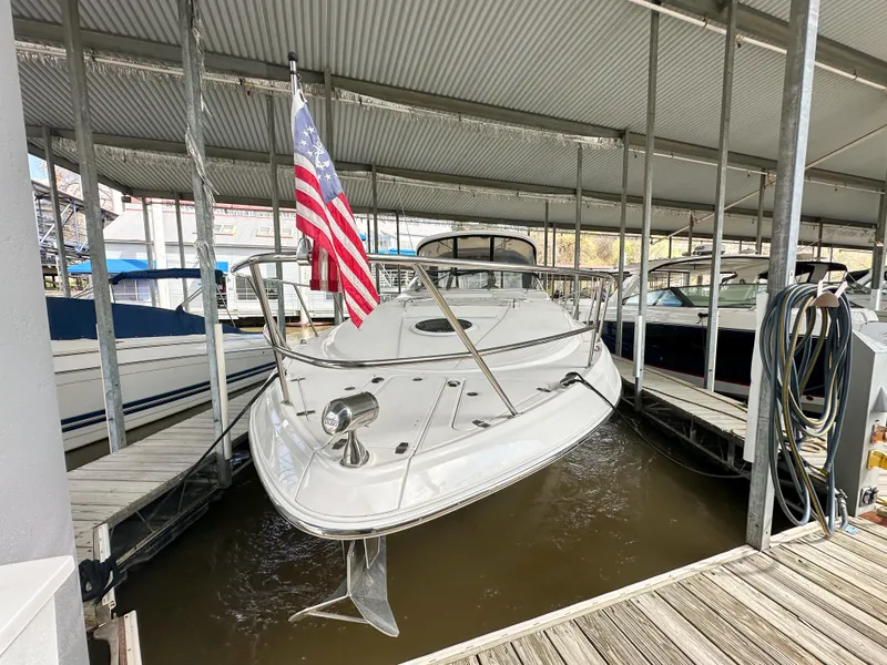 Slide: The Image of 2007 Regal Commodore 3760 IO boat docked under a covered marina with American flag. - 1