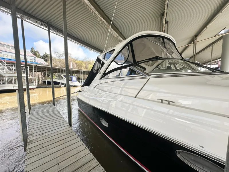Slide: The Image of 2007 Regal Commodore 3760 IO docked under a covered marina. - 2