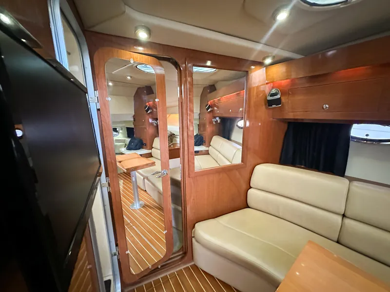 Slide: The Image of Luxurious interior of 2007 Regal Commodore 3760 IO yacht with wood accents and plush seating. - 24