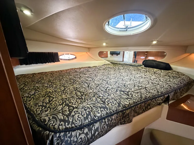 Slide: The Image of Luxurious cabin interior of 2007 Regal Commodore 3760 IO with elegant bedding and porthole. - 31