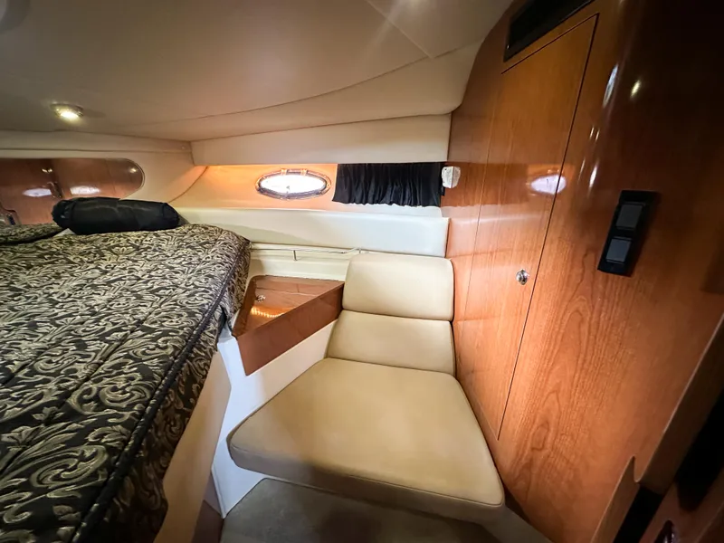 Slide: The Image of 2007 Regal Commodore 3760 IO cabin interior with bed, seating, and wood paneling. - 32