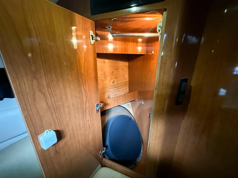 Slide: The Image of Wooden cabinet interior on 2007 Regal Commodore 3760 IO boat, featuring shelves and lighting. - 33