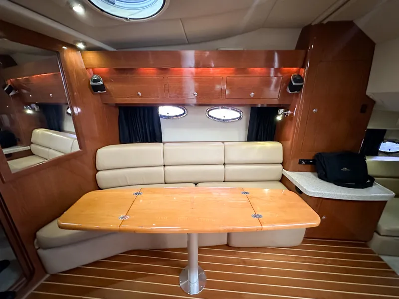 Slide: The Image of 2007 Regal Commodore 3760 IO cabin interior with wood accents and beige seating. - 36