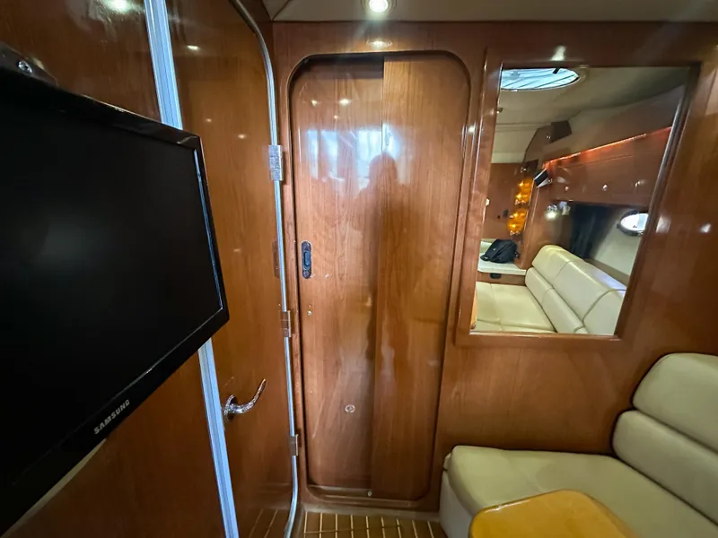 Slide: The Image of Interior of 2007 Regal Commodore 3760 IO yacht with wood paneling and seating area. - 37