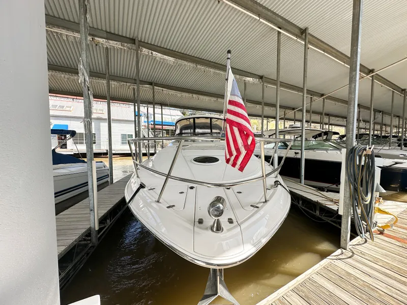 Slide: The Image of 2007 Regal Commodore 3760 IO boat docked under a covered marina with American flag. - 39