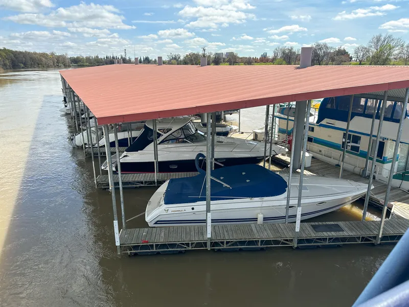 Slide: The Image of 2007 Regal Commodore 3760 IO docked under a red-roofed marina shelter. - 40