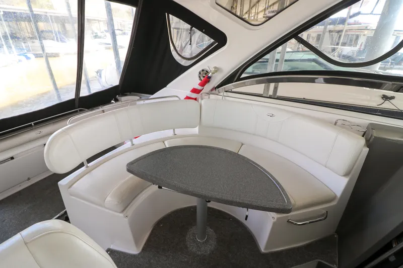 Slide: The Image of 2007 Regal Commodore 3760 IO boat interior with white seating and a central table. - 5
