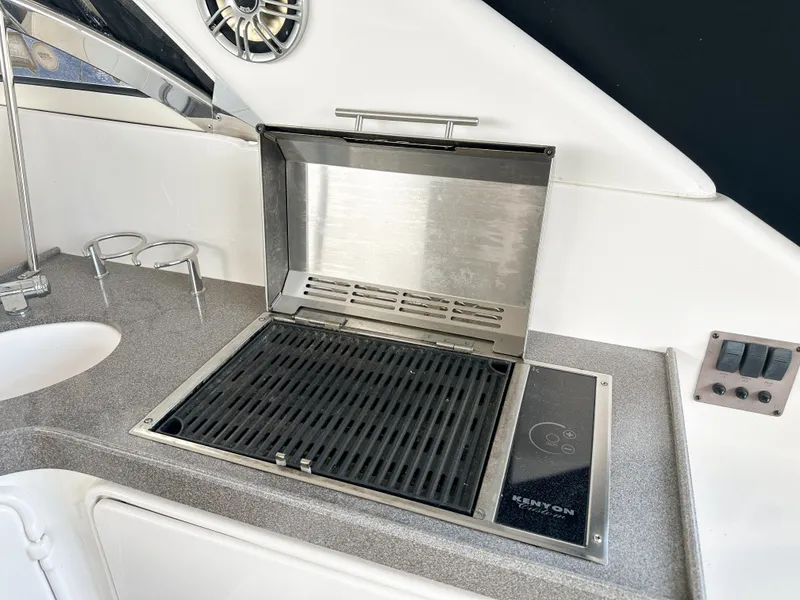 Slide: The Image of Outdoor grill on 2007 Regal Commodore 3760 IO boat, featuring sleek stainless steel design. - 7