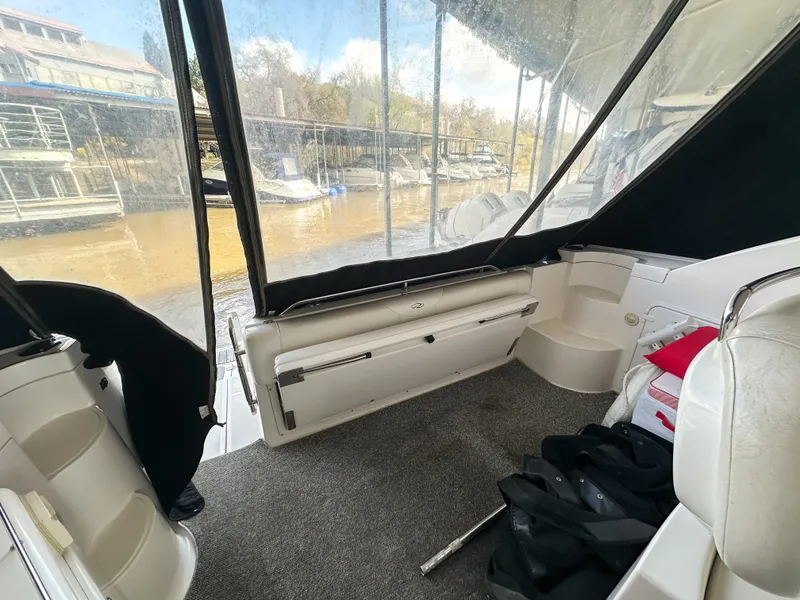 Slide: The Image of 2007 Regal Commodore 3760 IO boat interior with seating and marina view. - 8
