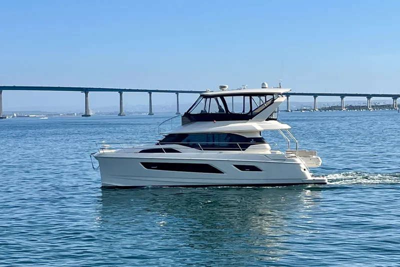 Slide: The Image of 2017 Aquila 44 Yacht cruising on calm waters near a bridge. - 58