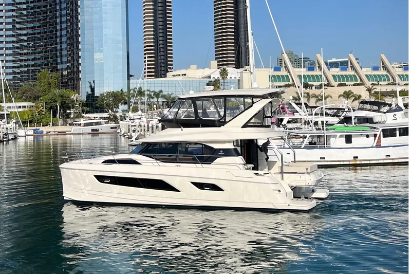 Slide: The Image of 2017 Aquila 44 Yacht docked in a marina with cityscape background. - 6